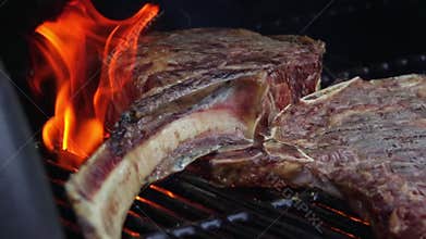 Beef steaks on the grill with flames
