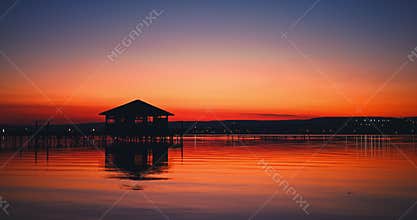 Maldives island sunset on the beach at a tropical resort with water villa, luxury house bungalow