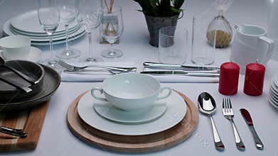 Buffet table setting, serving tableware on the table, white plate fork and knife.