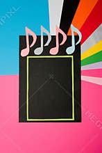 elegant music background, black paper with a green frame on a gray background, musical notes