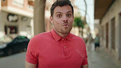 Young hispanic man smiling confident with amaze expression at street