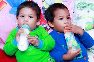 Kids drink bottled formula milk