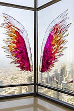 Dubai, UAE - 07.18.2021 - Wings application on the glass at the highest observation deck in world. 125th floor of Burj Khalifa.