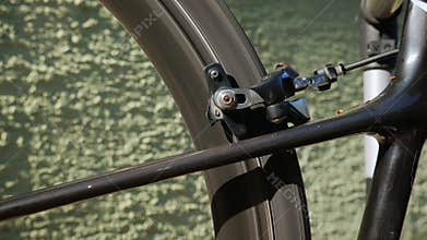 Bicycle brake pads in details. Rotating bike wheel. Bicycle wheel details