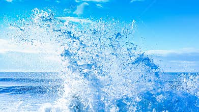 Fresh clean refreshing Summer ocean water splash against blue sky on a hot day
