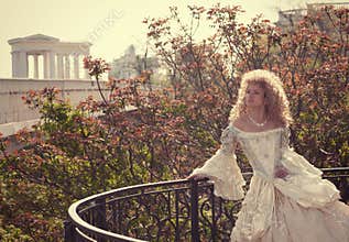 Princess leaning on railing of the balcony