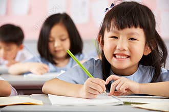 Students Working At Desks In Chinese School