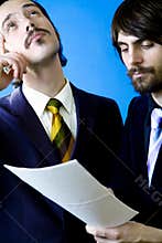 businessmen studying contract