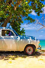 Vintage car at a beach in Cuba