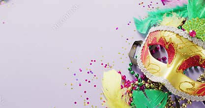 Video of carnival masquerade mask, feathers, confetti and mardi gras beads, with copy space