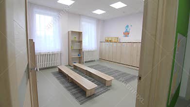Wooden benches and cabinets in kindergarten locker room