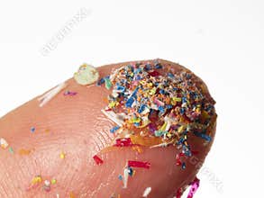 Microplastics in water - polluted water - macro photography of finger with microplatics
