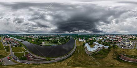 aerial seamless spherical 360 hdri panorama overlooking old town, historic buildings with bridge across wide river with dark sky