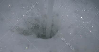Water pours into the bath forming a large lush white foam. The foam in the bathroom rises from the pouring water. To