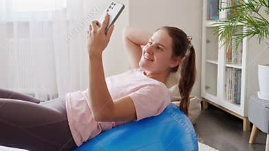 Beautiful woman shooting video of herself on fitness training. Sports, fitness and yoga bloggers and influencers