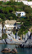 Rock cliff houses at Cala Feola bay on Ponza Island in Italy
