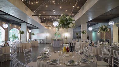 Served tables for a holiday in a restaurant. Glasses, plates, cutlery, napkins.