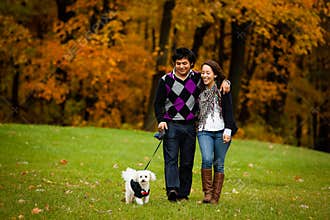 Happy Couple with Dog During Autumn