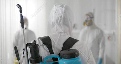 People in virus protective ppe suit discussing hospital disinfection plan