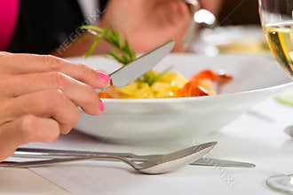People fine dining in elegant restaurant