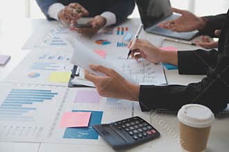 Financial analysts analyze business financial reports on a digital tablet planning investment project during a discussion at a