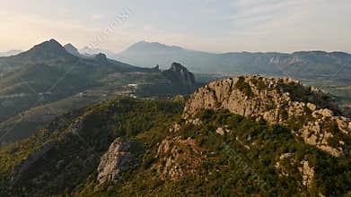 aerial scenic landscape with green fields, meadows, curved mountain river and mountain ridge with high mountains and