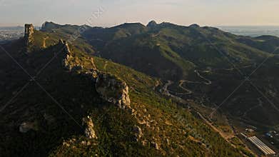 aerial scenic landscape with green fields, meadows, curved mountain river and mountain ridge with high mountains and