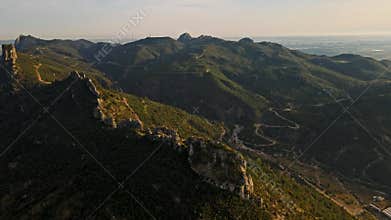 aerial scenic landscape with green fields, meadows, curved mountain river and mountain ridge with high mountains and
