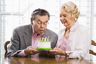 Mature couple with cake.
