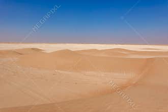 Small cross desert dunes golden on the horizon limestone expanse