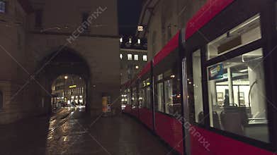 Tram rushes at night in front of the historic Zytglogge (clock tower) in Bern, Switzerland capital city