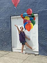 senior adult woman holding balloons