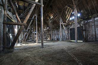 Old wooden barn with light shining through wooden boards