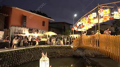 Crowded people walking night street market. life style in the night at canal Chiangmai, Thailand