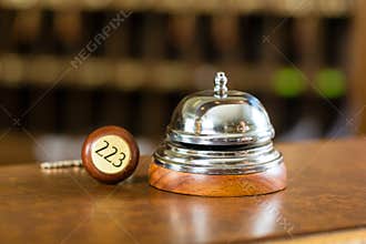 Reception - Hotel bell and key lying on the desk
