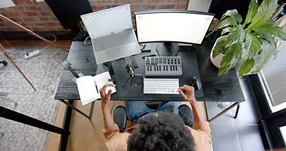 Over head of african american man podcasting at home, slow motion