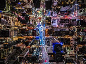 Night life in modern metropolis. Birds eye shot of high rise buildings and streets. Large display on Times Square