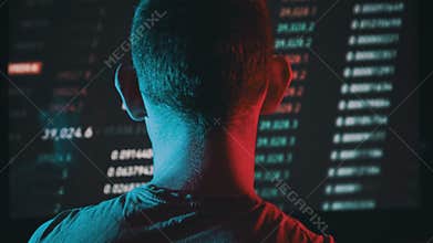 Trader Analyze Cryptocurrency Charts on a Big Screen in the Dark