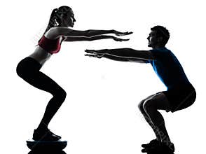 Coach man woman exercising squats on bosu