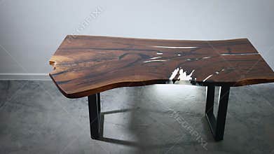 Luxury kitchen table made of wood slab and epoxy resin. Premium and exclusive furniture