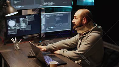 Young IT programmer wearing cervical collar at office