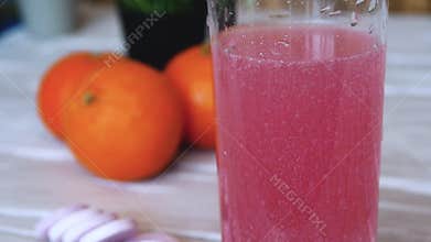 Close-up Vitamin pop with water. The concept of drinking vitamin c in tablets. Fruit juice or freshly squeezed. Medicinal