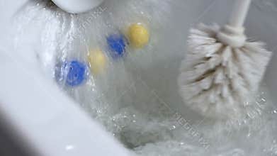 Close-up of an antiseptic against fungus remedy. Flush the toilet with foamy soapy water. Scented balls for the toilet.