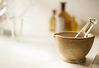 Mortar and pestle with drug vial and bottles
