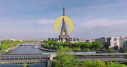 Paris, France, 07 April 2023: The logo of the Paris 2024 Olympic Games on a green metro train driving over the famous
