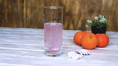 Close-up Vitamin pop with water. The concept of drinking vitamin c in tablets. Fruit juice or freshly squeezed. Medicinal