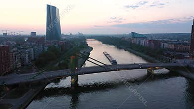 Downhill Flight through Frankfurt am Main, on the river Main. A ship passes under a bridge.
