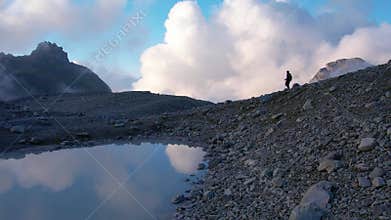 Drone Captures Hiker on Mountainous Terrain at Dusk