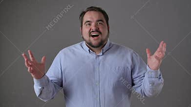 Excited Man Expresses Enthusiasm and Joy in Studio Setting