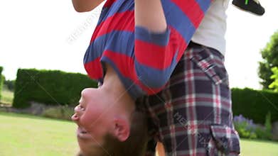 Family Having Fun Playing In Garden